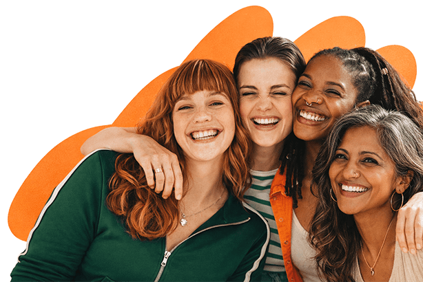 Three multicultural female friends smiling and embracing each other